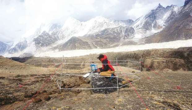 In this undated handout photo released by the Survey Department, Nepal on December 1, 2020 a team member conducts a gravity survey during Mount Everestu2019s height measurements.