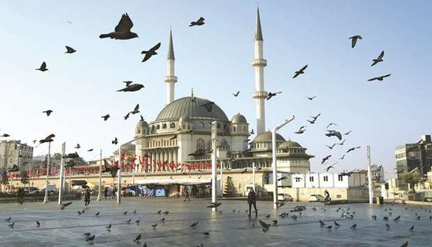 Pigeons fly over the Taksim Square during a nation-wide weekend curfew imposed to prevent the spread of the coronavirus disease in Istanbul on December 5. Turkey will follow through its pledges to carry out economic and legal reforms, Treasury and Finance Minister Lutfi Elvan said yesterday, in an effort to lure much-needed foreign investment.