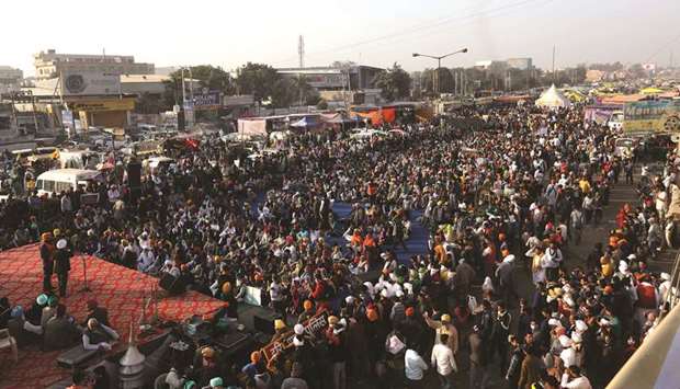 Farmers attend a protest during a nationwide strike against the newly passed farm bills at Singhu border near Delhi yesterday.