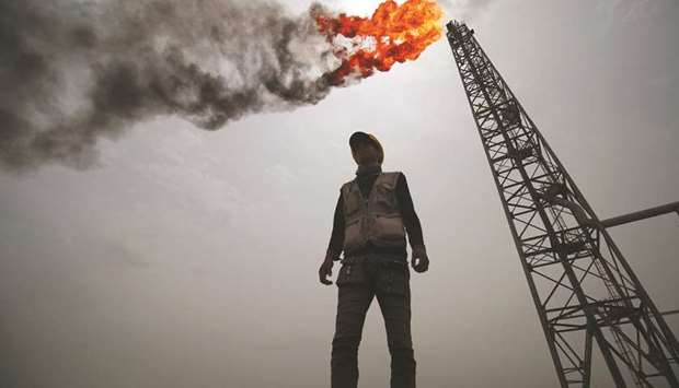 An employee stands at the Hammar Mushrif new Degassing Station Facilities site inside the Zubair oil and gas field, north of the southern Iraqi province of Basra (file). Iraqu2019s economy will contract 12% this year, more than that of any other Opec member under a production quota, according to International Monetary Fund forecasts.