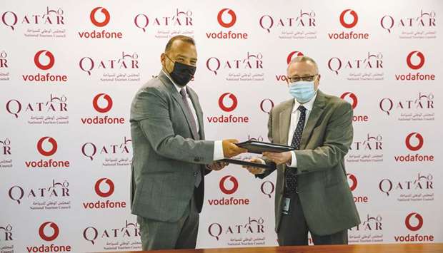Vodafone Qataru2019s COO Diego Camberos and QNTCu2019s COO Berthold Trenkel at the MoU signing ceremony.