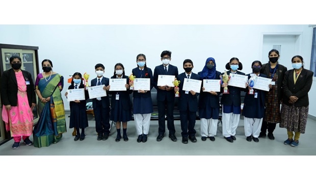 The MES Indian School team which won the overall championship are seen with school officials.