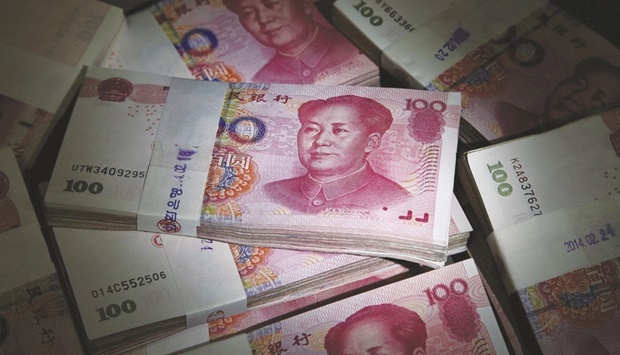 Bundles of yuan banknotes are arranged for a photograph at the Korea Exchange Bank headquarters in Seoul. Chinau2019s central bank took further steps to limit the yuanu2019s strength, a day after policy makers made their most substantial move yet to rein in the currencyu2019s surge against the dollar.