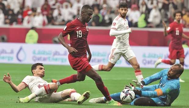Qataru2019s forward Almoez Ali is fouled by UAEu2019s defender Mohnad Salem (left) and goalkeeper Ali Khaseif (right) during the FIFA Arab Cup quarter-final at Al Bayt Stadium in Al Khor. PICTURE: Noushad Thekkayil