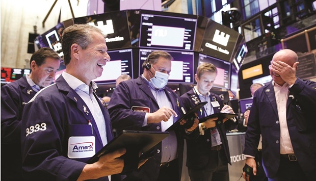 Traders work on the floor of the New York Stock Exchange (file). Investors are bracing for the last Federal Reserve meeting of the year, with market participants hungry to learn how quickly the central bank plans to finish unwinding its bond-buying programme and pick up signs of when it may start to raise rates in 2022.