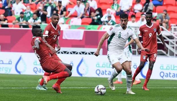 Algeria's forward Baghdad Bounedjah (right) attempts to get past Sudan defenders during the FIFA Arab Cup Group D match at the Ahmad bin Ali Stadium Wednesday. PICTURE: Shemeer Rasheed