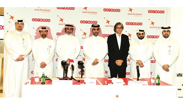 Ooredoo CEO Sheikh Mohamed bin Abdulla al-Thani and ICSS founder and chairman Mohammed Hanzab, who signed the agreement on Sunday, are joined by other dignitaries.