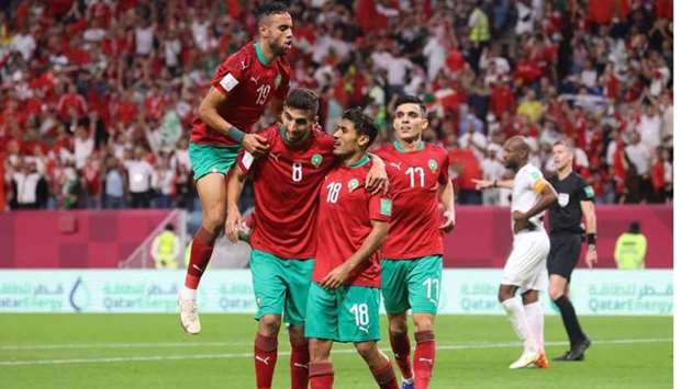:Morocco's midfielder Abdelilah Hafidi (C-R) celebrates with teammates after scoring the second goal during the FIFA Arab Cup 2021 group C football match between Morocco and Palestine at the Al-Janoub Stadium. AFP