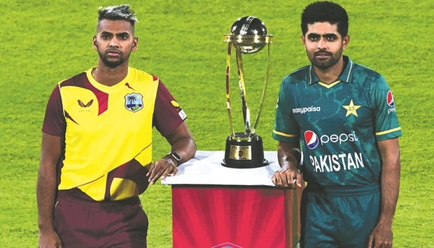 West Indiesu2019 captain Nicholas Pooran (left) and Pakistanu2019s skipper Babar Azam pose with the T20 trophy before the start of a practice session between the two teams at the National Stadium in Karachi yesterday. (AFP)