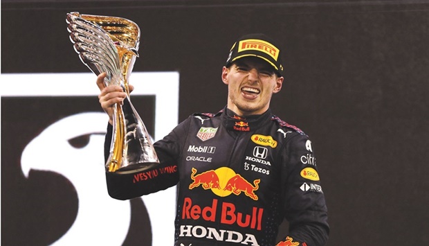 Red Bullu2019s Dutch driver Max Verstappen celebrates with trophy after winning the Abu Dhabi Grand Prix and the world championship title at the Yas Marina Circuit in Abu Dhabi. (Reuters)