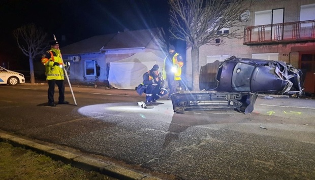 Police examine the scene of an accident near the Serbian border where a car carrying migrants crashed into a house, in Morahalom, Hungary. Police.hu/Handout via REUTERS
