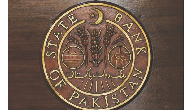 A logo of the State Bank of Pakistan (SBP) is pictured on a reception desk at the head office in Karachi (file). The bank has been facing a falling Pakistani rupee, high inflation and a current account deficit which prompted it to begin hiking rates as the countryu2019s government also struck a deal with the International Monetary Fund to revive a stalled $6bn funding plan.