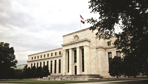 The Federal Reserve building in Washington, DC. Fed officials intensified their battle against the hottest inflation in a generation by shifting to an earlier end of their asset-buying programme and signalling they favour raising interest rates in 2022 at a faster pace than economists were expecting.