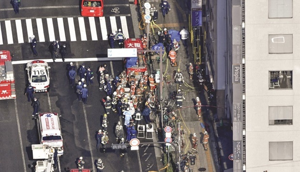 Firetrucks and firefighters are seen in front of a medical centre in Osaka, western Japan, in this photo  yesterday taken by Kyodo.