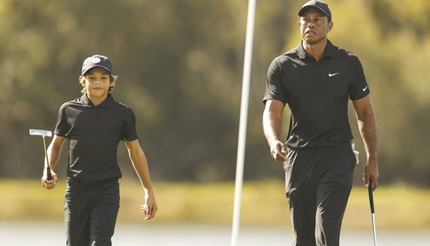 Tiger Woods and Charlie Woods walk on the course during the Pro-Am ahead of the PNC Championship on the Grande Lakes Orlando course in Orlando, Florida. (AFP)