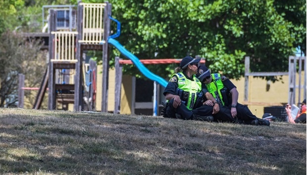 Members of the local police reacting near a playground outside the Hillcrest Primary School the day after five children died and four others were injured when a bouncy castle was blown into the air at an end-of-term school party in the Tasmania city of Devonport. Photo by Simon Sturzaker/various sources/AFP