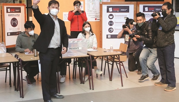 Chileu2019s presidential candidate Gabriel Boric shows his ballot at a polling station during the presidential election, in Punta Arenas, Chile, yesterday.