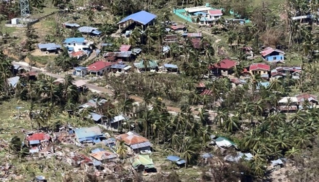 An aerial shot showing destroyed houses and fallen coconut trees in Cebu province on December 20, 2021, days after super Typhoon Rai devastated the province. (AFP)