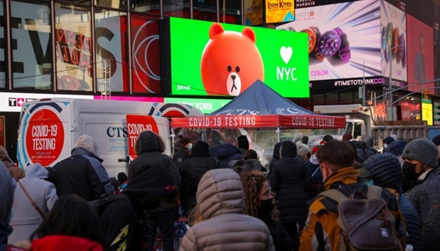 People wait to be tested for Covid-19 in Times Square, as the Omicron coronavirus variant continues to spread in Manhattan, New York City. REUTERS