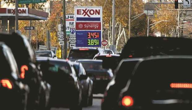 The price of gas is seen as traffic moves through Annapolis, MD on November 23. The US has repeatedly pushed Opec+ to accelerate output hikes as US gasoline prices soared and President Joe Bidenu2019s approval ratings slid.