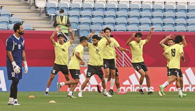 Iraq's players warm up ahead of the FIFA Arab Cup 2021 group A football match between Iraq and Oman at the Al-Janoub Stadium in Al-Wakrah