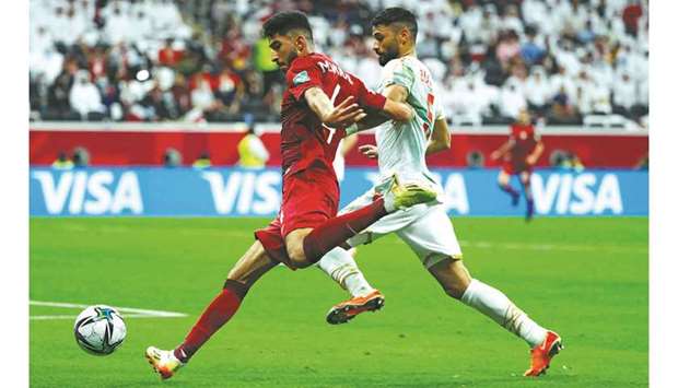 Bahrainu2019s defender Ahmed Bughammar (right) marks Qataru2019s midfielder Mohamed Waad during the FIFA Arab Cup 2021 Group A match at the Al-Bayt Stadium in Al-Khor on November 30, 2021. (AFP)