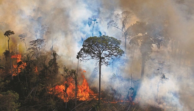 In this file photo taken on August 15, 2020 smoke rises from an illegally lit fire in Amazon rainforest reserve, south of Novo Progresso in Para State, Brazil. Extreme weather becoming more frequent and events highlighting social justice issues, such as the death of George Floyd in Minneapolis police custody, contributed to ESG rising to the top of the agenda of investors, companies and policy makers.