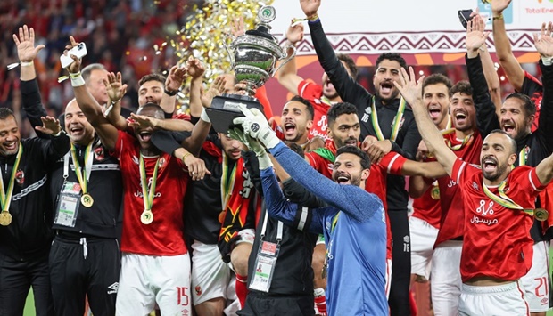 Ahly's players celebrate after winning the CAF Super Cup football match between Egypt's Al-Ahly and Morocco's Raja Club Athletic (Raja Casablanca) at the Ahmad Bin Ali Stadium.