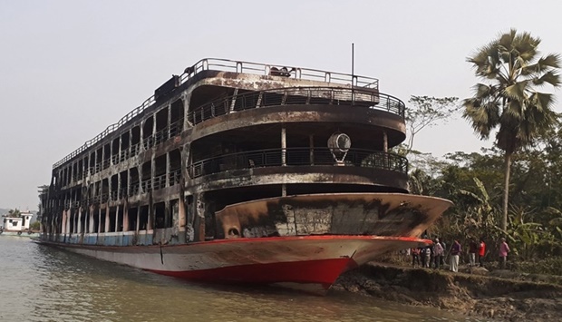 The burnt-out ferry is seen anchored along a coast after it caught fire killing at least 37 people in Jhalkathi, 250 km south of Dhaka. AFP