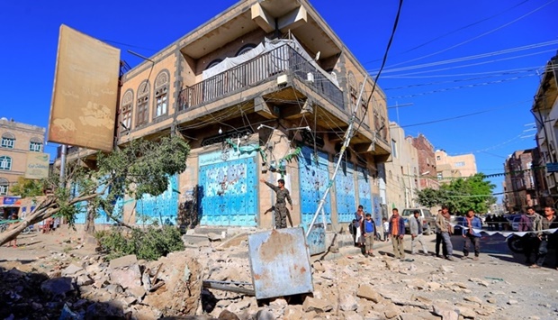 Yemenis inspect damage following a reported overnight air strike by the Saudi-led coalition targeting in the Huthi rebel-held capital Sanaa yesterday.