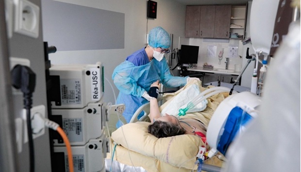 A nursing assistant tends to a patient infected with the coronavirus (Covid-19) at the reanimation unit of the Antoine Beclere hospital in Clamart, outside Paris, on December 23. AFP