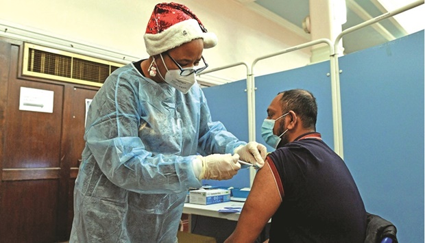 A National Health Service (NHS) health worker administers a dose of the coronavirus (Covid-19) vaccine at a pop-up vaccination centre at the Redbridge Town Hall, east London, on Satruday.
