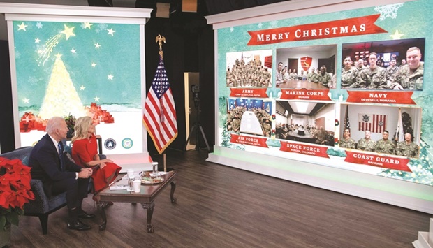 US President Joe Biden and US First Lady Jill Biden, with their new dog Commander, speak virtually with military service members to thank them for their service and wish them a Merry Christmas, from the South Court Auditorium of the White House in Washington, DC.