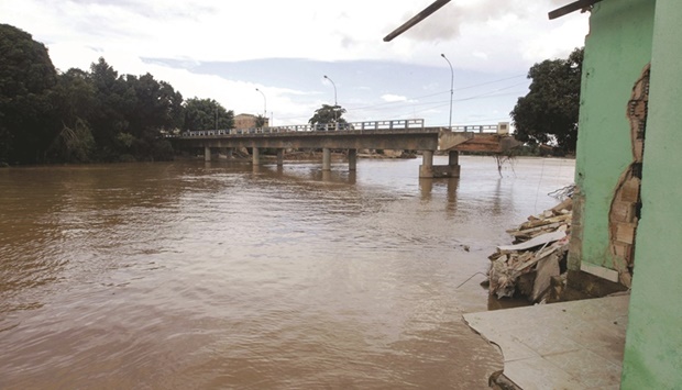 Handout picture released by the Bahia state government shows a river passing under a collapsed bridge following heavy rains, in Itamaraju, south of Bahia state, Brazil.
