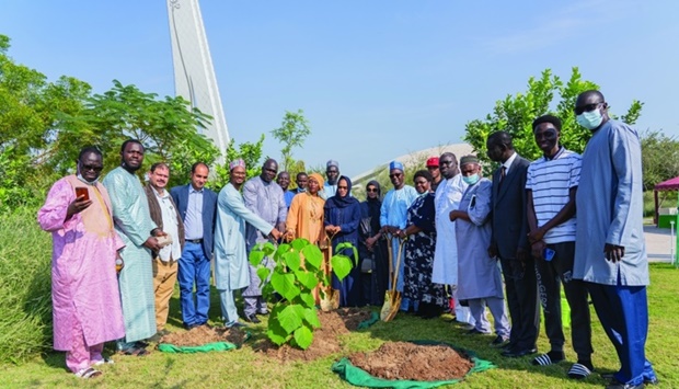 The First Lady of Gambia, Fatoumatta Bah-Barrow, ambassador Foday Malang, his wife Oumie S W Ndow, and other members of the delegation, plants the Gambian tree at QBGu2019s African Womenu2019s Diplomatic Garden.