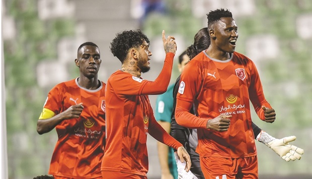 Al Duhailu2019s Michael Olunga (right) celebrates with teammates after scoring against Al Ahli during the QNB Stars League match at the Hamad bin Khalifa Stadium yesterday. PICTURE: Noushad Thekkayil