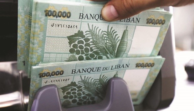 Lebanese pound banknotes are seen at a currency exchange shop in Beirut. The  currency has lost more than 90% of its value in two years, and four out five Lebanese are living under the UNu2019s poverty threshold.