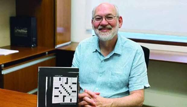Dr Leonard Williams with a copy of his latest book of puzzles.