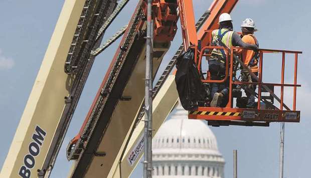 A construction crew works at a site near the US Capitol in Washington, DC. US employment growth slowed considerably in November amid job losses at retailers and in local government education, but the unemployment rate plunged to a 21-month low of 4.2%, suggesting the labour market was rapidly tightening.
