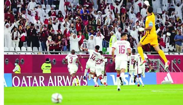 Qatar players celebrate with fans after securing a dramatic 2-1 win over Oman and seal their place in the FIFA Arab Cup quarter-finals at the Education City Stadium Friday. PICTURE: Noushad Thekkayil