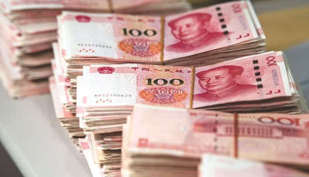 Bundles of 100 yuan notes seen at a bank in Shanghai. China will cut the amount of cash banks have to keep in reserve to aid smaller firms, Premier Li Keqiang said on Friday, although he didnu2019t say when the reduction would happen.