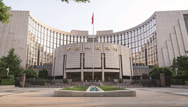 The Peopleu2019s Bank of China headquarters building in Beijing. Chinau2019s central bank said yesterday it would cut the amount of cash that banks must hold in reserve, its second such move this year, releasing $188bn in long-term liquidity to bolster slowing economic growth.