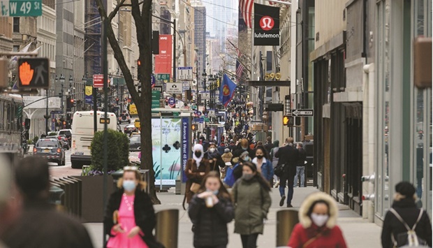 People walk on a busy 5th Avenue in midtown Manhattan in New York City. The winds of inflation in the US strengthened further in November with consumer prices projected to show the largest annual advance in decades, keeping pressure on the Federal Reserve to deliver swifter policy tightening.