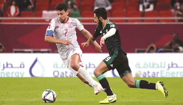 Tunisia's Youssef Msakni in action with United Arab Emirates' Bandar Al-Ahbabi.