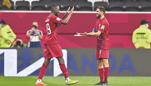 Qatar captain midfielder Hassan al-Haydos (left) celebrates with teammate Almoez Ali after the hosts win over Iraq at the FIFA Arab Cup at Al Bayt Stadium in Al Khor on Monday. PICTURE: Noushad Thekkayil