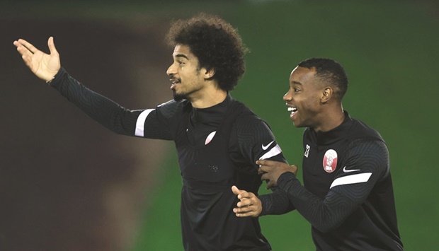 Qataru2019s Akram Afif (left) and teammate Assim Madibo during a training session.