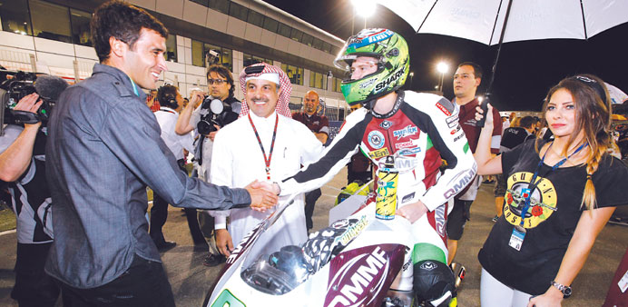 QMMF Racing Team rider Anthony West with QMMF president Nasser Khalifa al-Attiyah (centre) and footballer Raul (left).