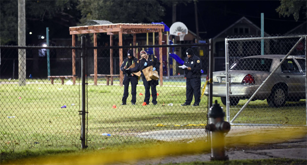 Police gather evidence after a shooting at a playground in New Orleans, Louisiana