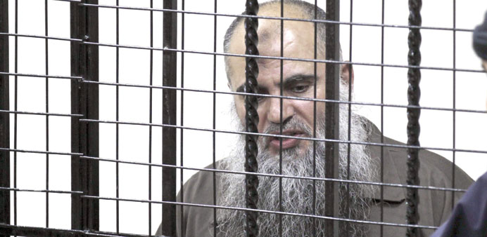 Abu Qatada is pictured behind bars at the state security court in Amman yesterday.