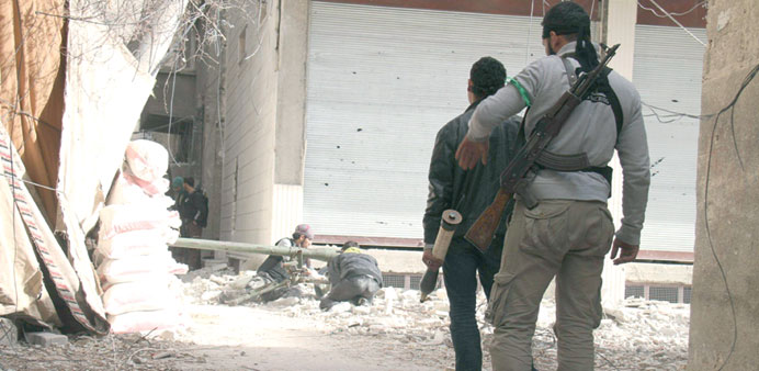 Free Syrian Army fighters are seen on the frontline in a suburb of Damascus yesterday.